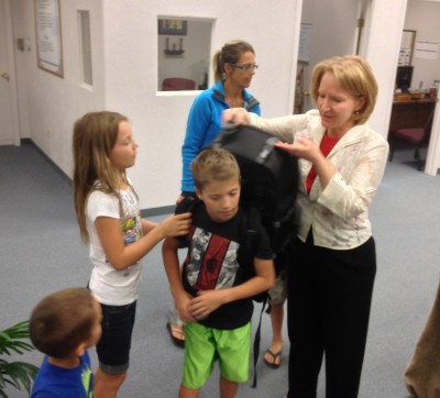 Ethan and our other children try on the "missions backpack." This backpack contains tools and resources to hike into hard-to-reach areas to present the gospel.